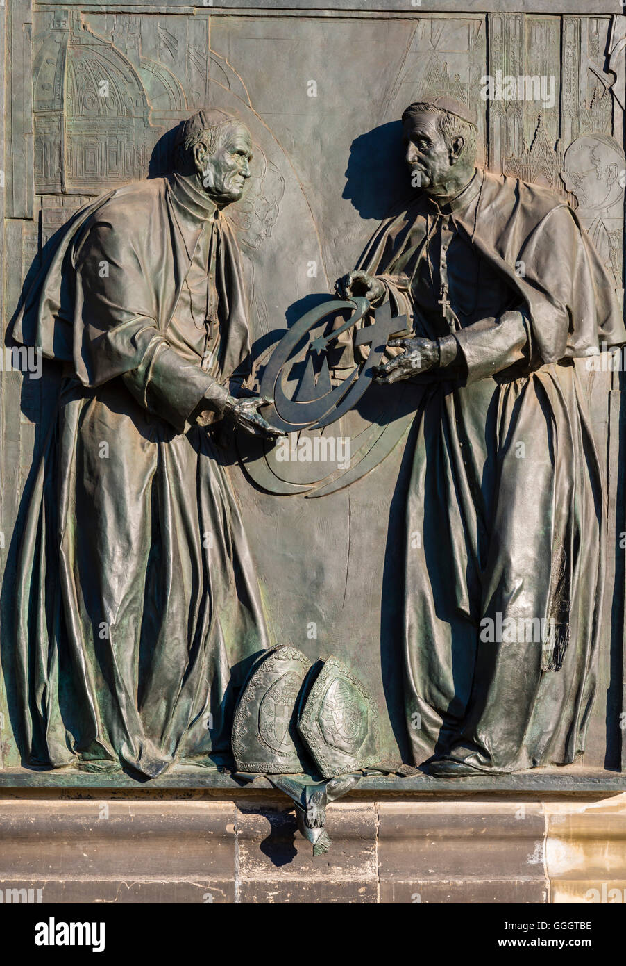 geography / travel, Germany, North Rhine-Westphalia, Pope John Paul II delivering his successor Pope Benedict XVI the Cross of the World Youth Day, bronze relief by the Duesseldorf artist Bert Gerresheim at Cologne cathedral for the memorization of the World Youth Day 2005, sanctified by cardinal Joachim Meisner on 15th May 2009, Cologne, Freedom-Of-Panorama Stock Photo