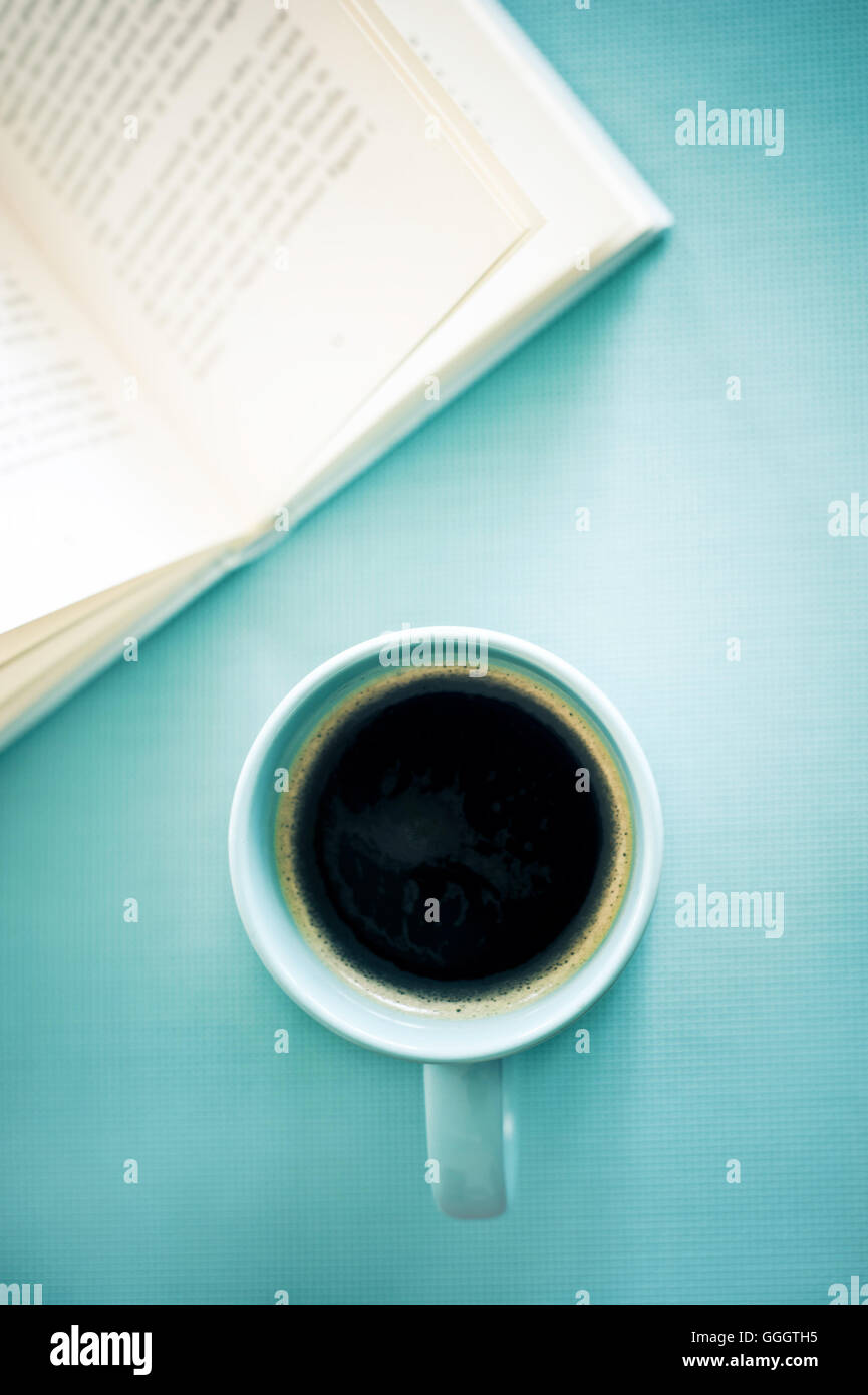 mug with black coffee and book Stock Photo