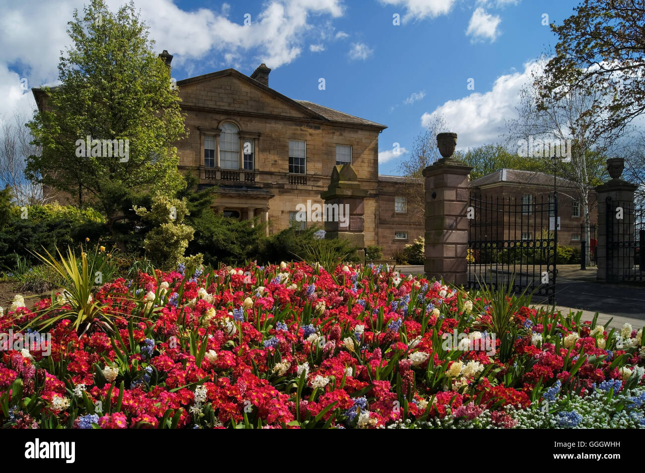 UK,South Yorkshire,Rotherham,Clifton Park Museum and Entrance with Spring Flower Bed Stock Photo