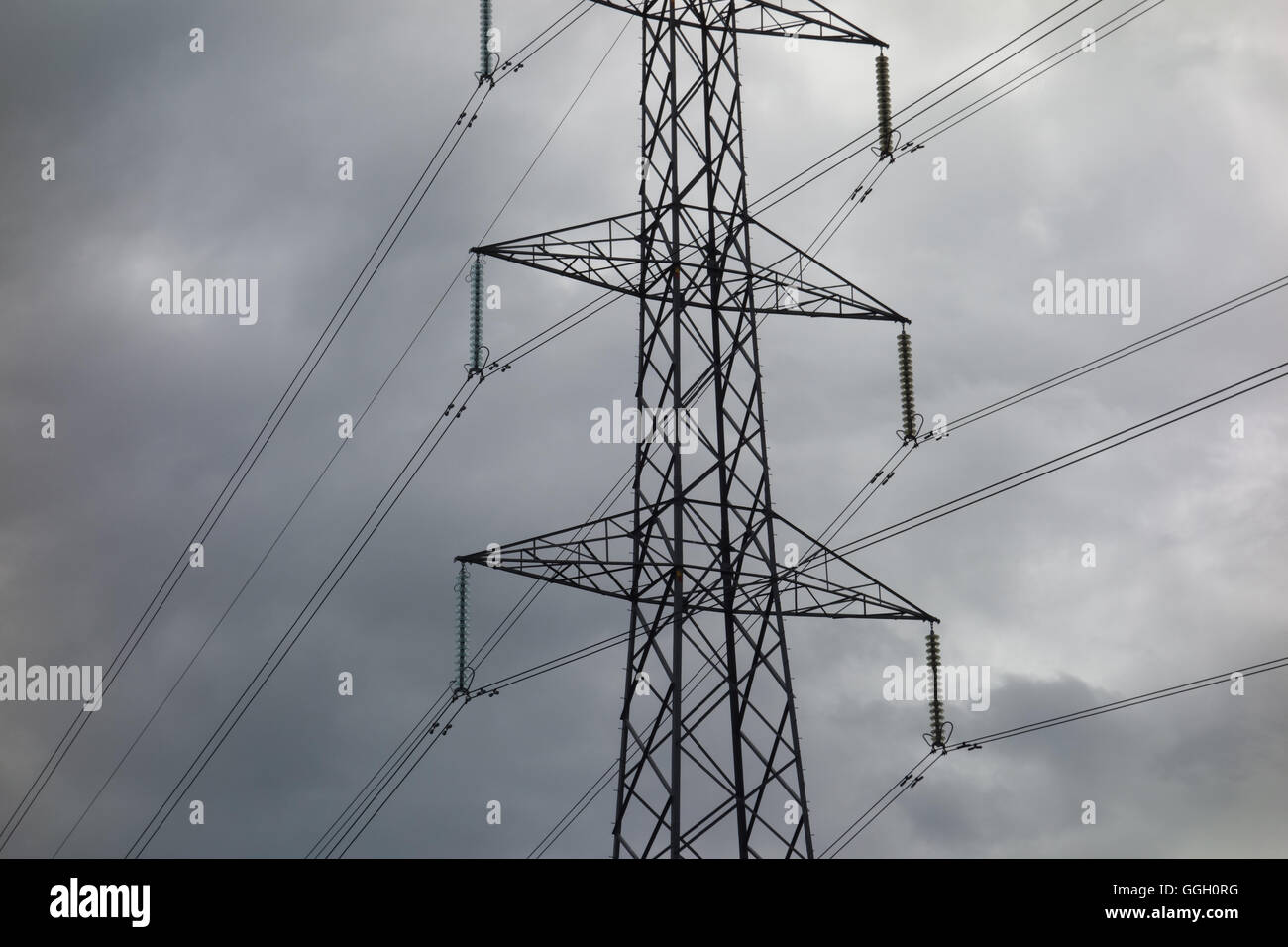Electricity power line pylon in front of storm clouds Stock Photo - Alamy