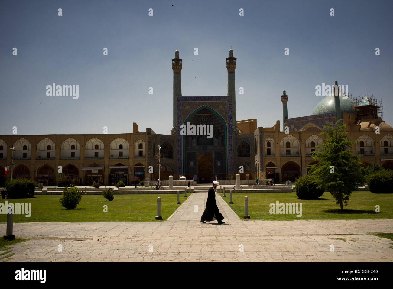 A mullah crosses in front of Shah Mosque at the Naqsh-e Jahan Square of Isfahan, Iran. © Jordi Boixareu Stock Photo