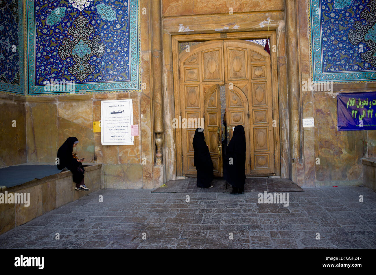 Women at the main entrance of the Shah Mosque at the Naqsh-e Jahan Square of Isfahan, Iran. © Jordi Boixareu Stock Photo