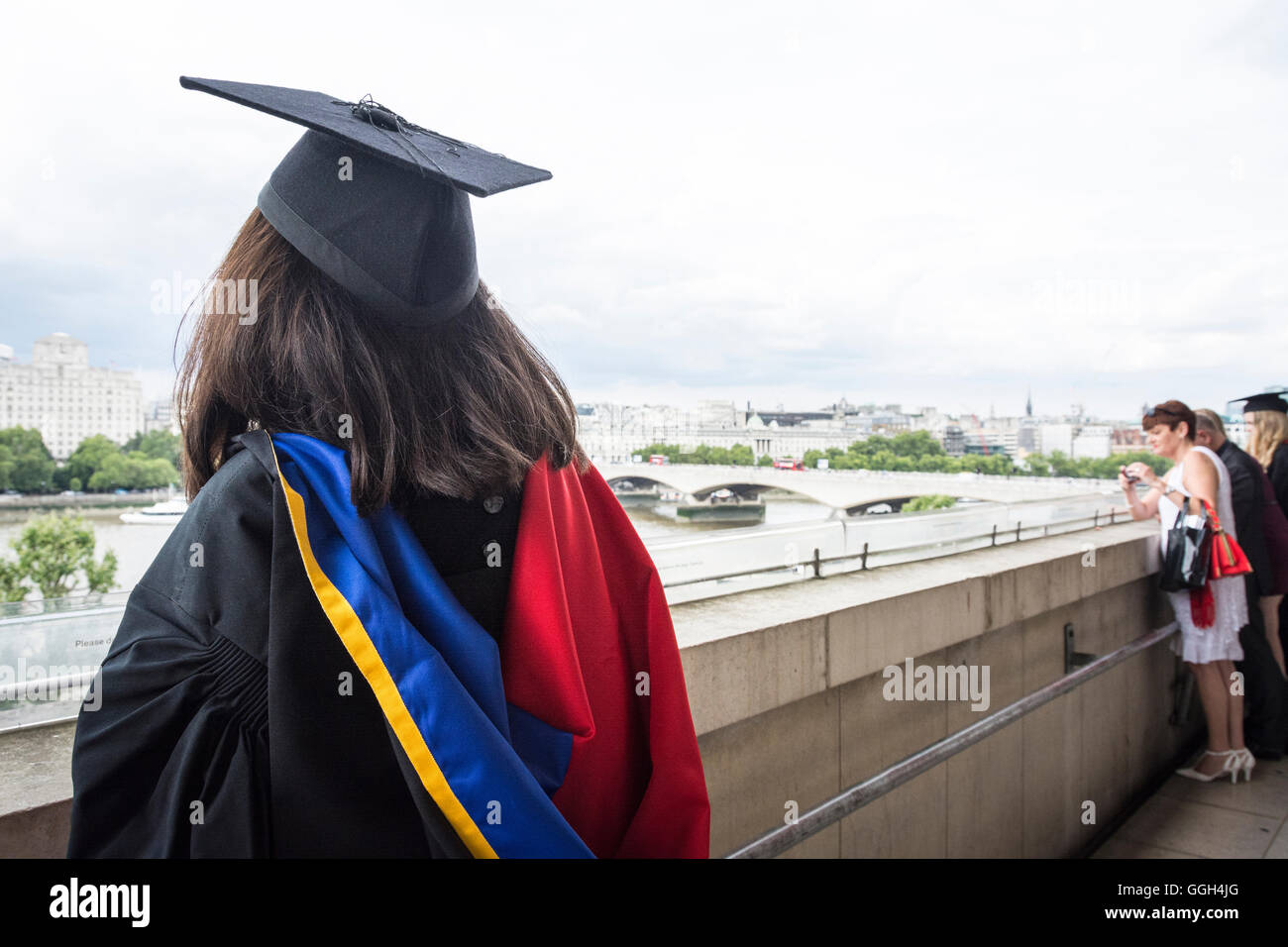 Graduation day - a young university graduate wearing a mortarboard looks towards future horizons from the Royal Festival Hall, London, England, U.K. Stock Photo
