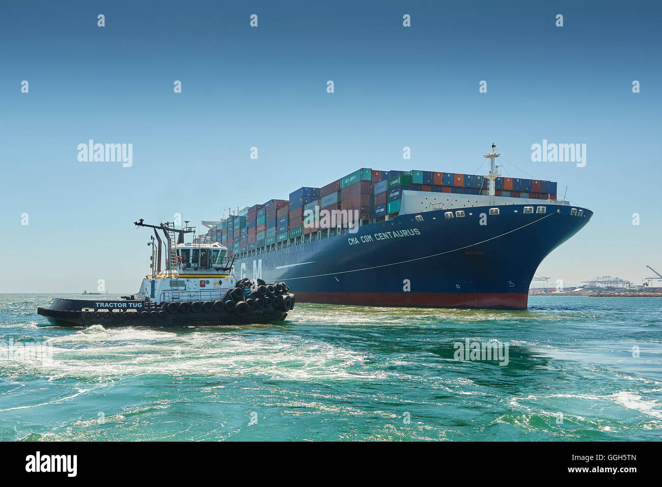The CMA CGM Centaurus Container Ship Is Manoeuvred Towards Pier J In The Long Beach Container Terminal, Los Angeles, California, USA. Stock Photo
