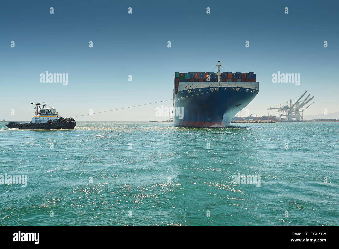 The Giant CMA CGM Centaurus Container Ship Is Manoeuvred Towards Pier J In The Long Beach Container Terminal, California, USA. Stock Photo