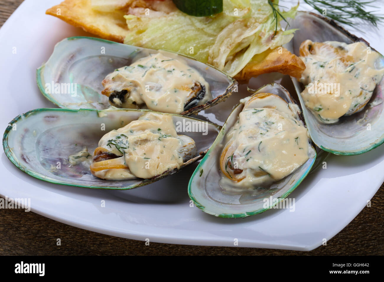 Baked mussels in cream sauce with rosemary Stock Photo Alamy