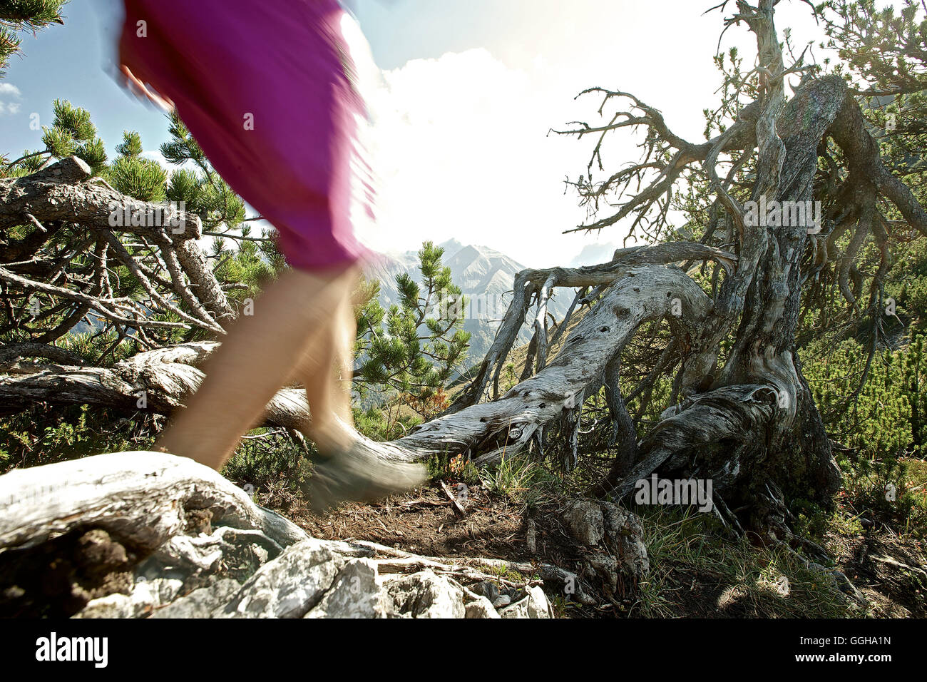 Young woman hiking in the mountains on a sunny day, Oberstdorf, Bavaria, Germany Stock Photo