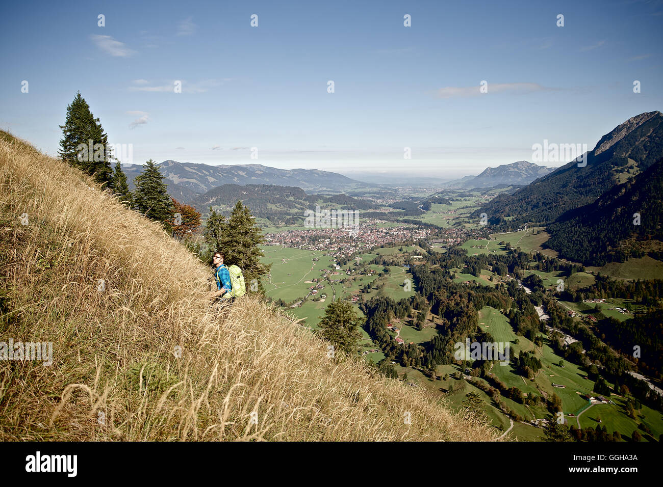 Young man hiking up mountain hi-res stock photography and images - Alamy
