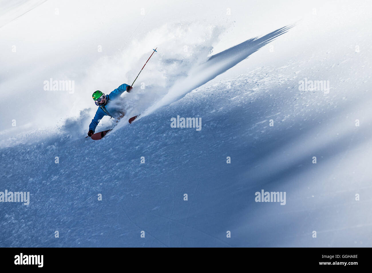 Young male freeskier riding through the deep powder snow in the mountains, Pitztal, Tyrol, Austria Stock Photo