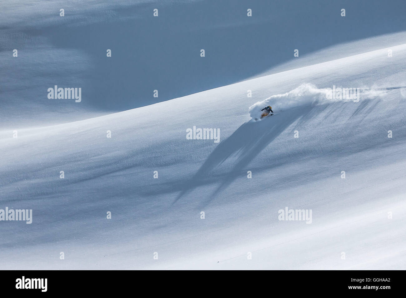 Young female freeskier riding through deep powder snow in the mountains, Pitztal, Tyrol, Austria Stock Photo