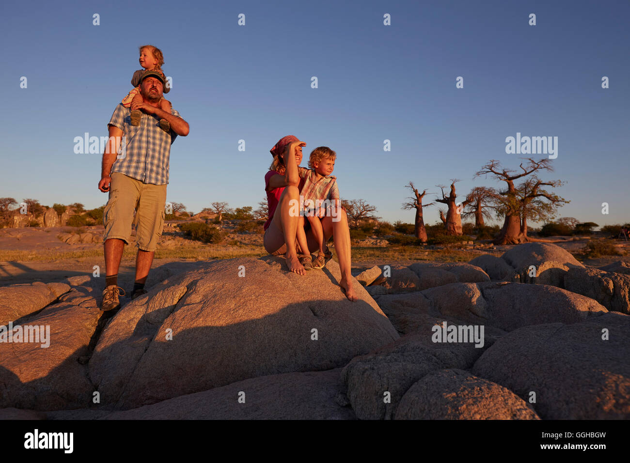 Family looking at view at sunset, Kubu Island, Makgadikgadi Pans National Park, Botswana Stock Photo