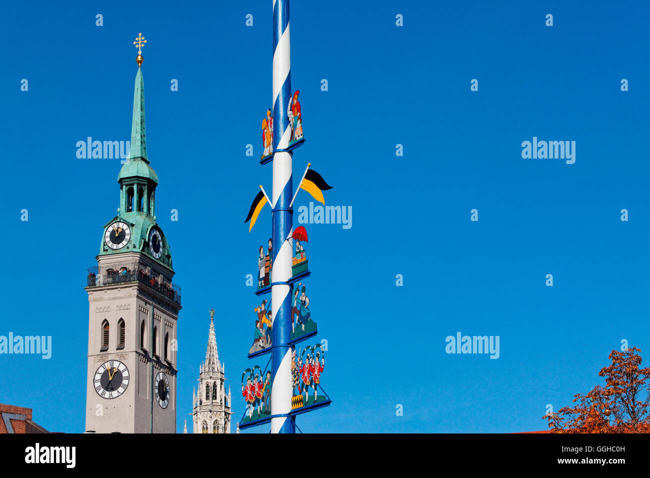 Steeples of St. Peter's church and the city hall, May pole at Viktualienmarkt, Munich, Upper Bavaria, Bavaria, Germany Stock Photo