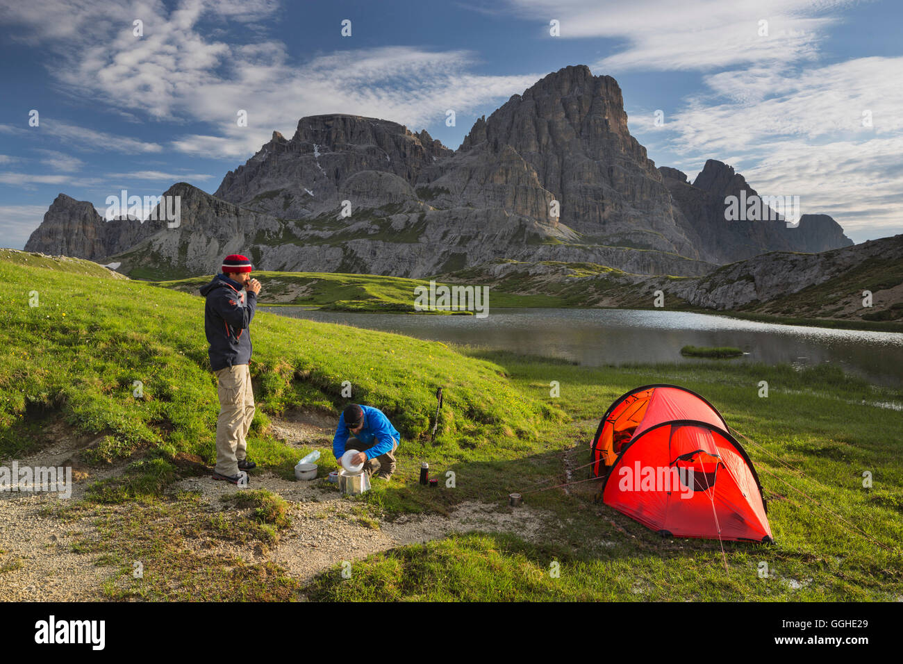 Hikers at Neunerkofel, red tent, Boedenalpe, Bodenseen lake, South Tyrol, Dolomites, Italy Stock Photo