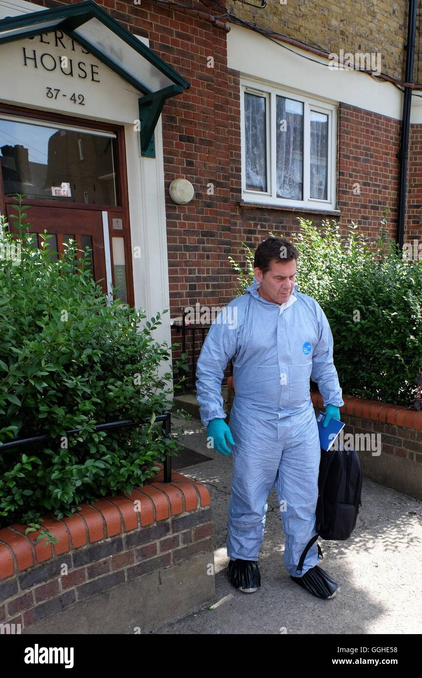A forensic officer leaves Robertson House in Tooting, London, as neighbours of 19-year-old Zakaria Bulhan, who is being held over the Russell Square knife attack, described him as a 'quiet' and 'pleasant' young man who enjoyed playing football with his younger brother. Stock Photo