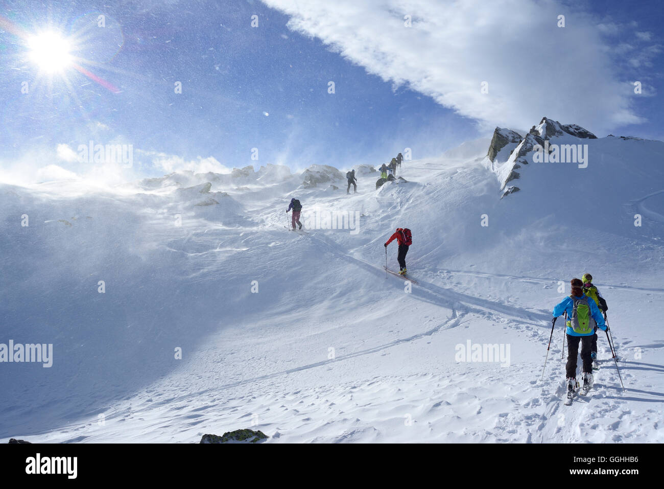Back-country skiers ascending through snowstorm to Regenfeldjoch, Langer Grund, Kitzbuehel Alps, Tyrol, Austria Stock Photo