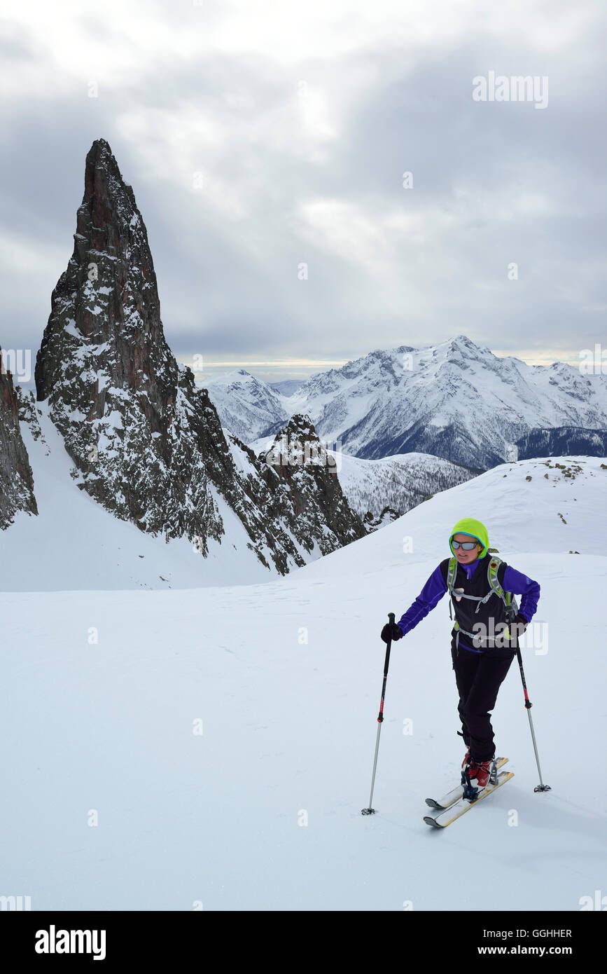 Female back-country skier ascending to Cima Cece, Lagorai, Fiemme Mountains, Trention, Italy Stock Photo