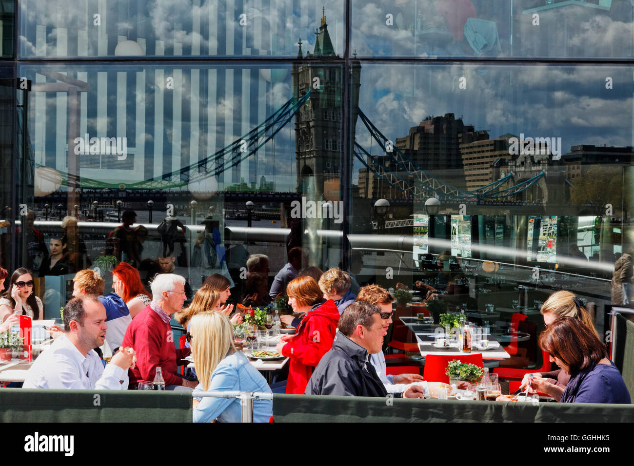 Reflection of Tower bridge in a facade of a restaurant at the More London Riverside complex, Southwark, London, England, United Stock Photo