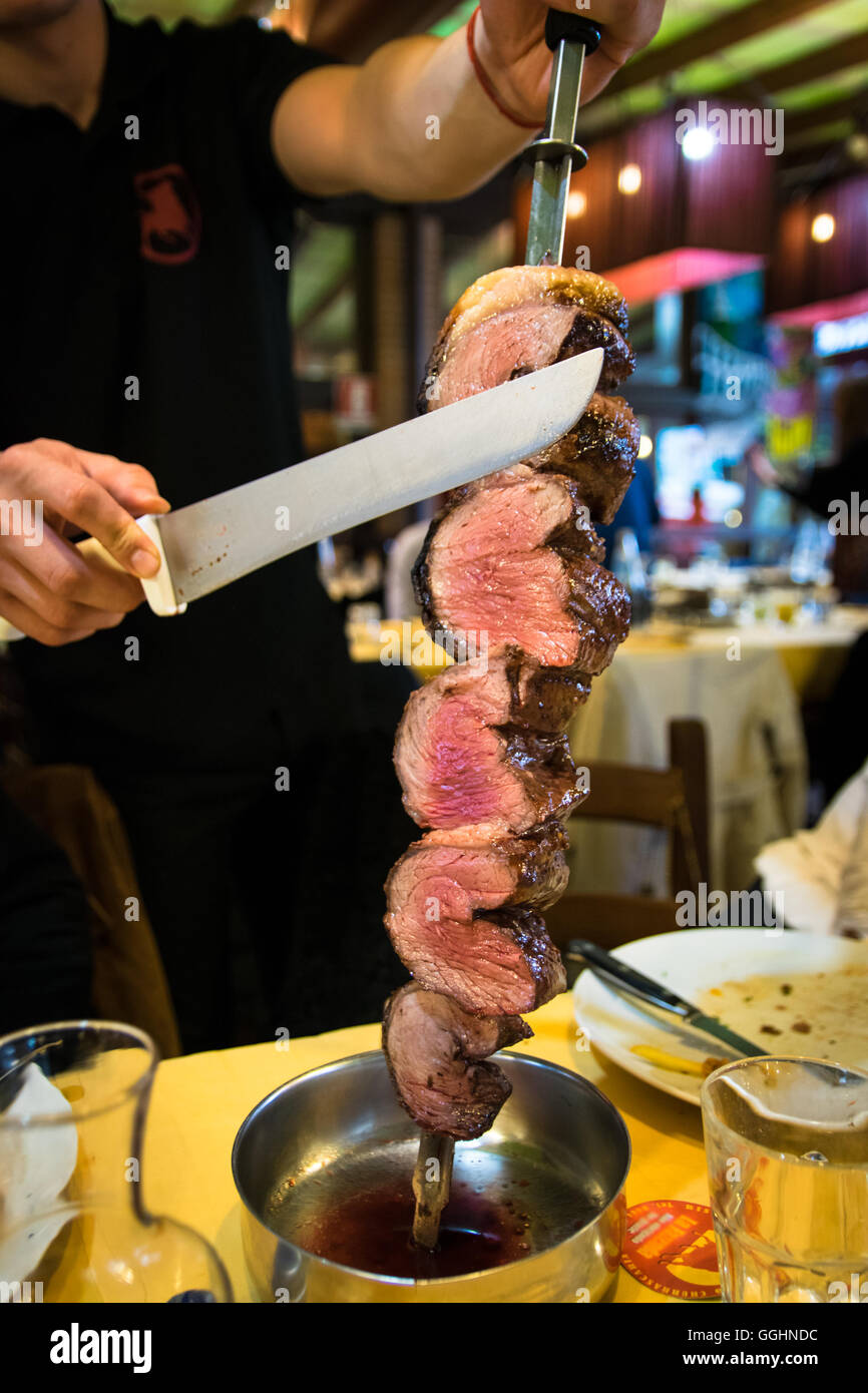 Picanha, traditional Brazilian barbecue sliced directly at the restaurant  table Stock Photo - Alamy