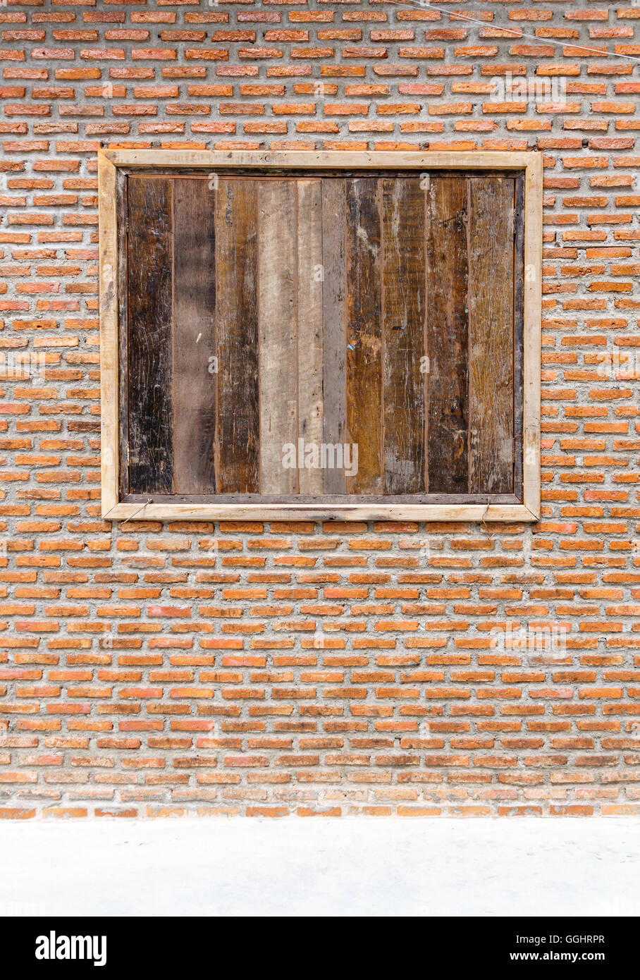 Grunge wood window on orange brick wall background texture Stock Photo