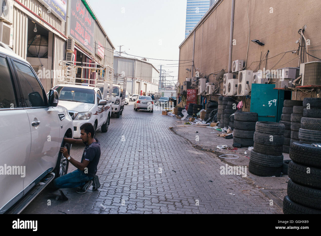 Sharjah, UAE. A man at work in a car repairs yard in an industrial area