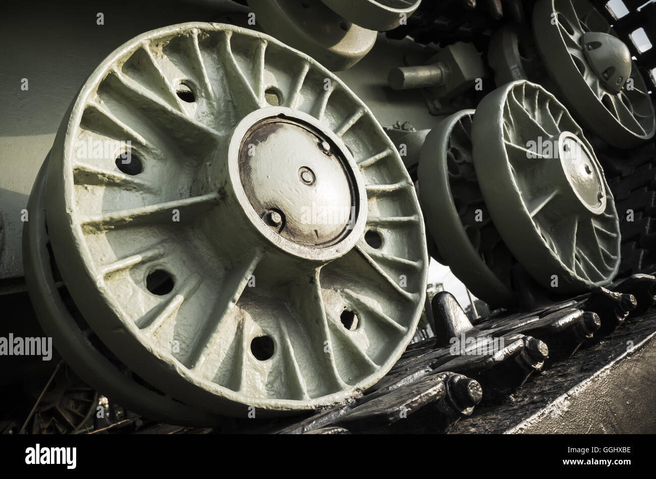 Green tank wheels. Closeup photo, heavy industry details Stock Photo