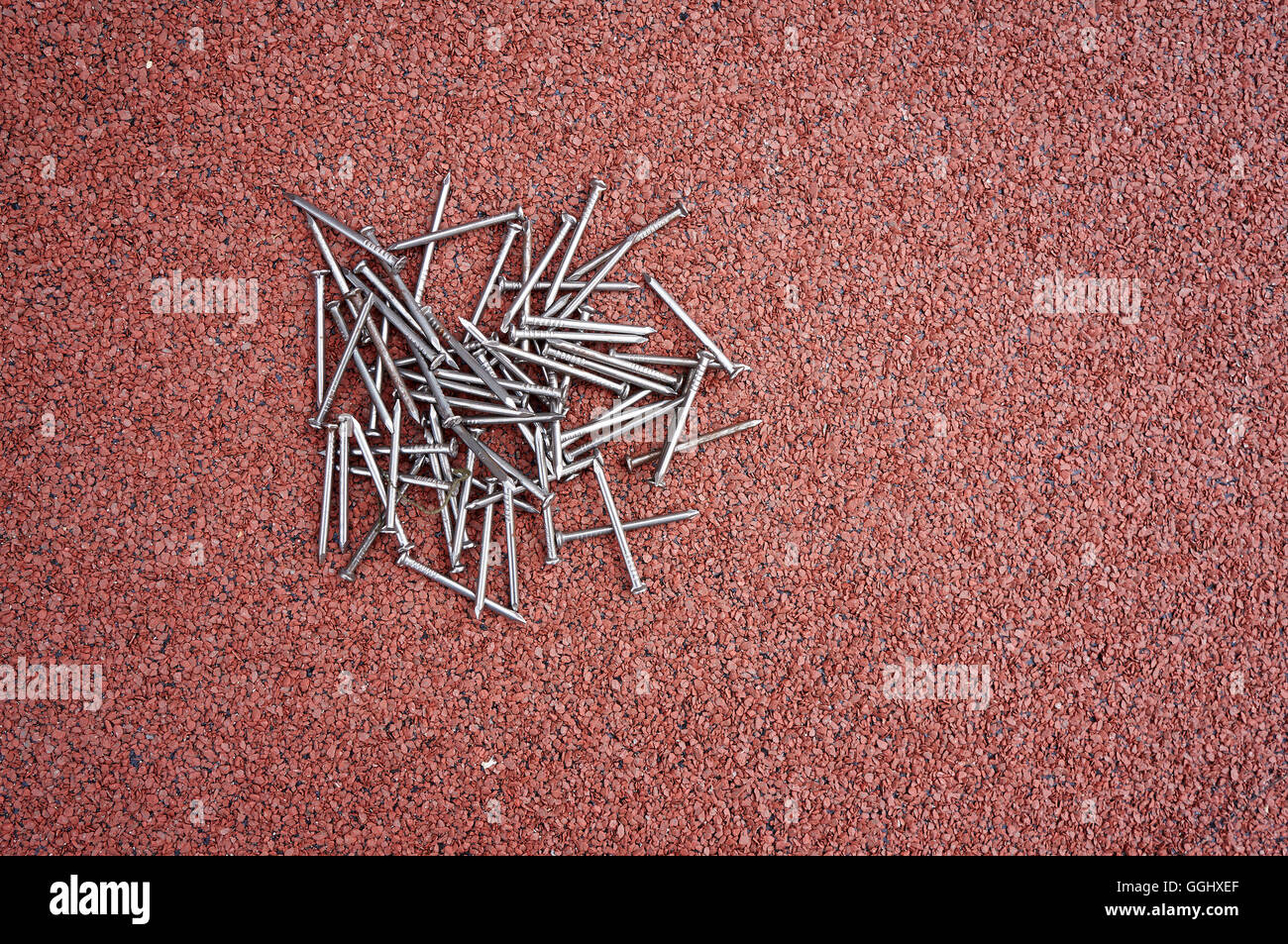 Do it yourself, nails on red roof shingles Stock Photo Alamy