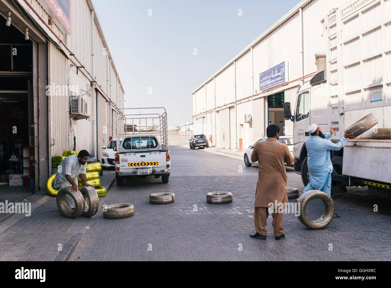 Sharjah, UAE. Men at work in a car repairs yard in an industrial area