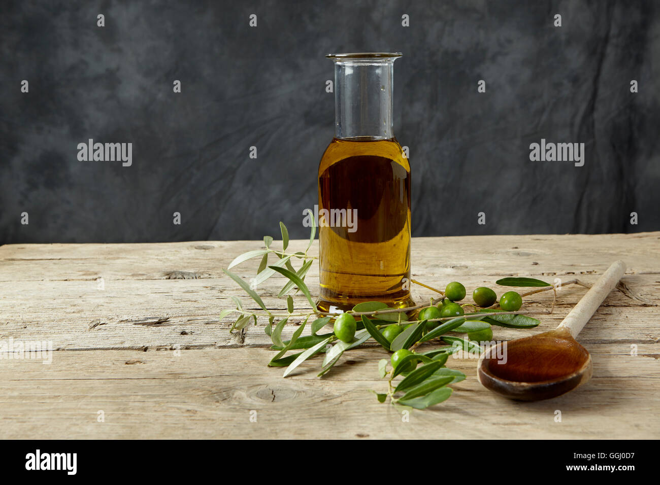 Olive branch and olive oil on the wooden table Stock Photo - Alamy