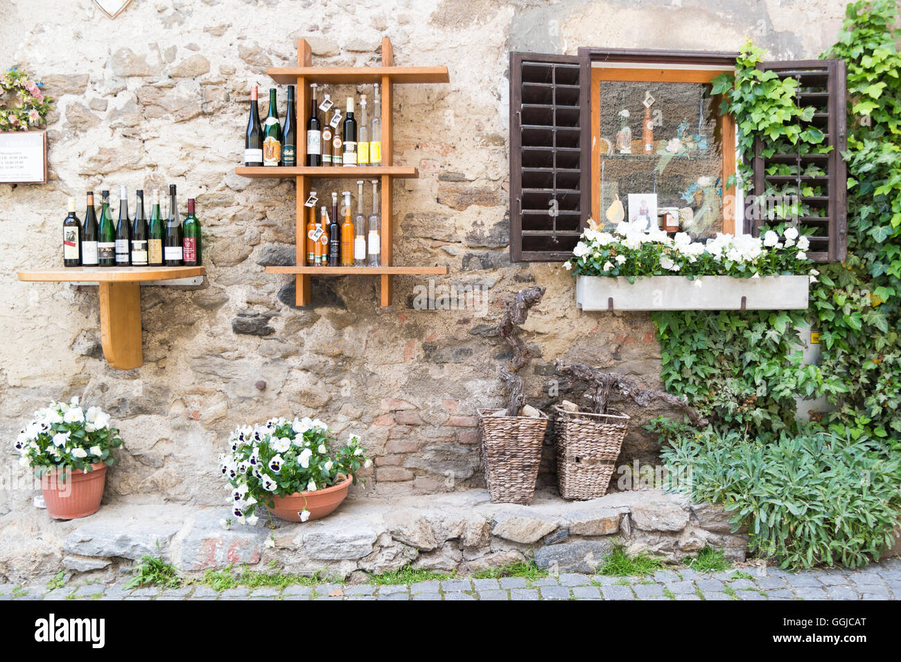 Display of wine bottles outside liquor store in Main Street of old town Durnstein in Wachau valley, Lower Austria Stock Photo