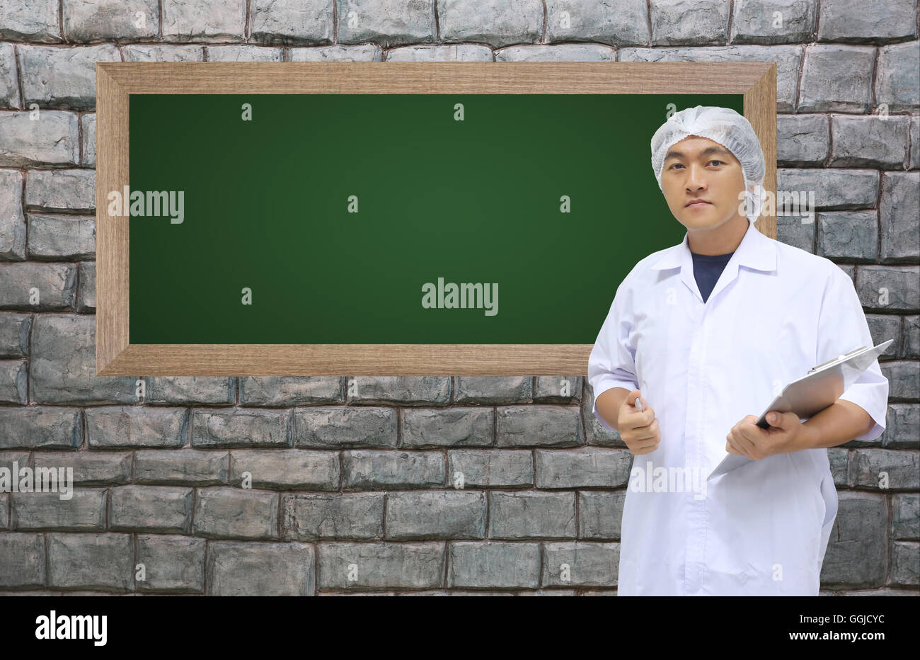 A Man in doctor white dress on stone wall and have blackboard for your Input text or data,health concept and medicine. Stock Photo