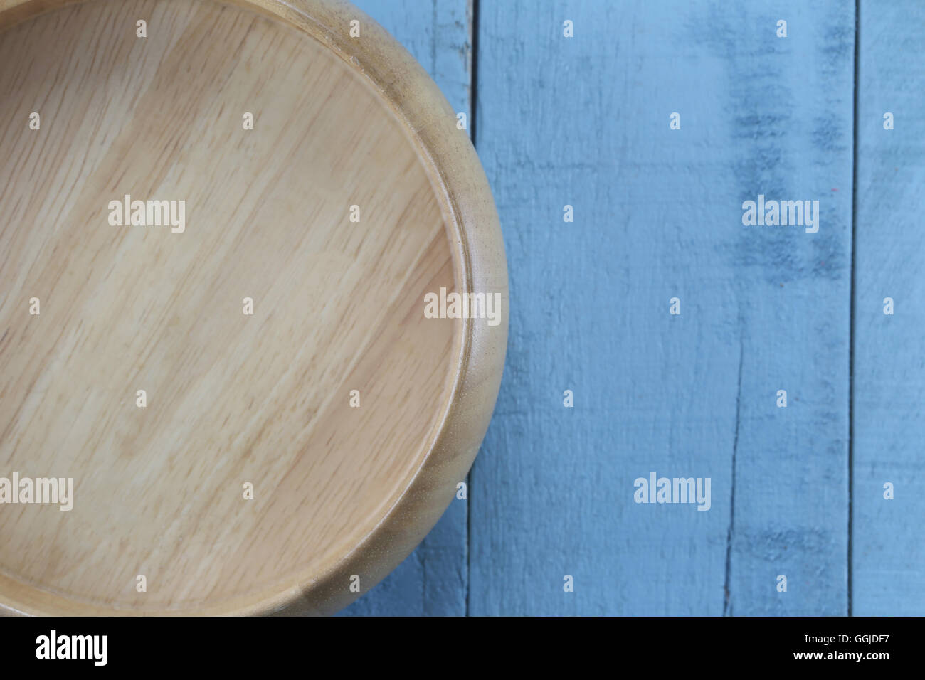 Wooden bowl of Kitchen utensils on the blue wood background. Stock Photo