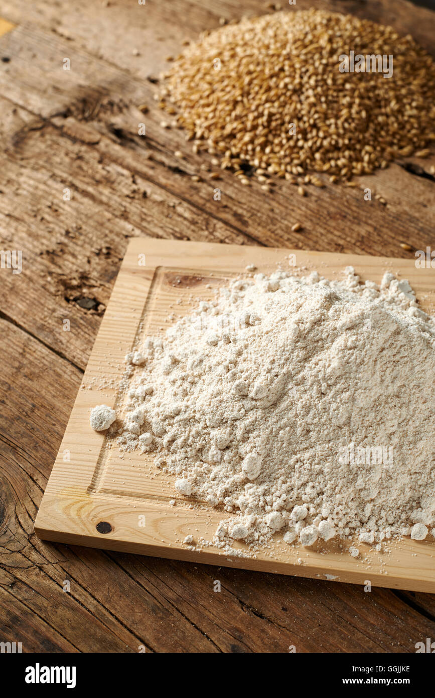 flour with wheat on a wooden kitchen bench Stock Photo Alamy