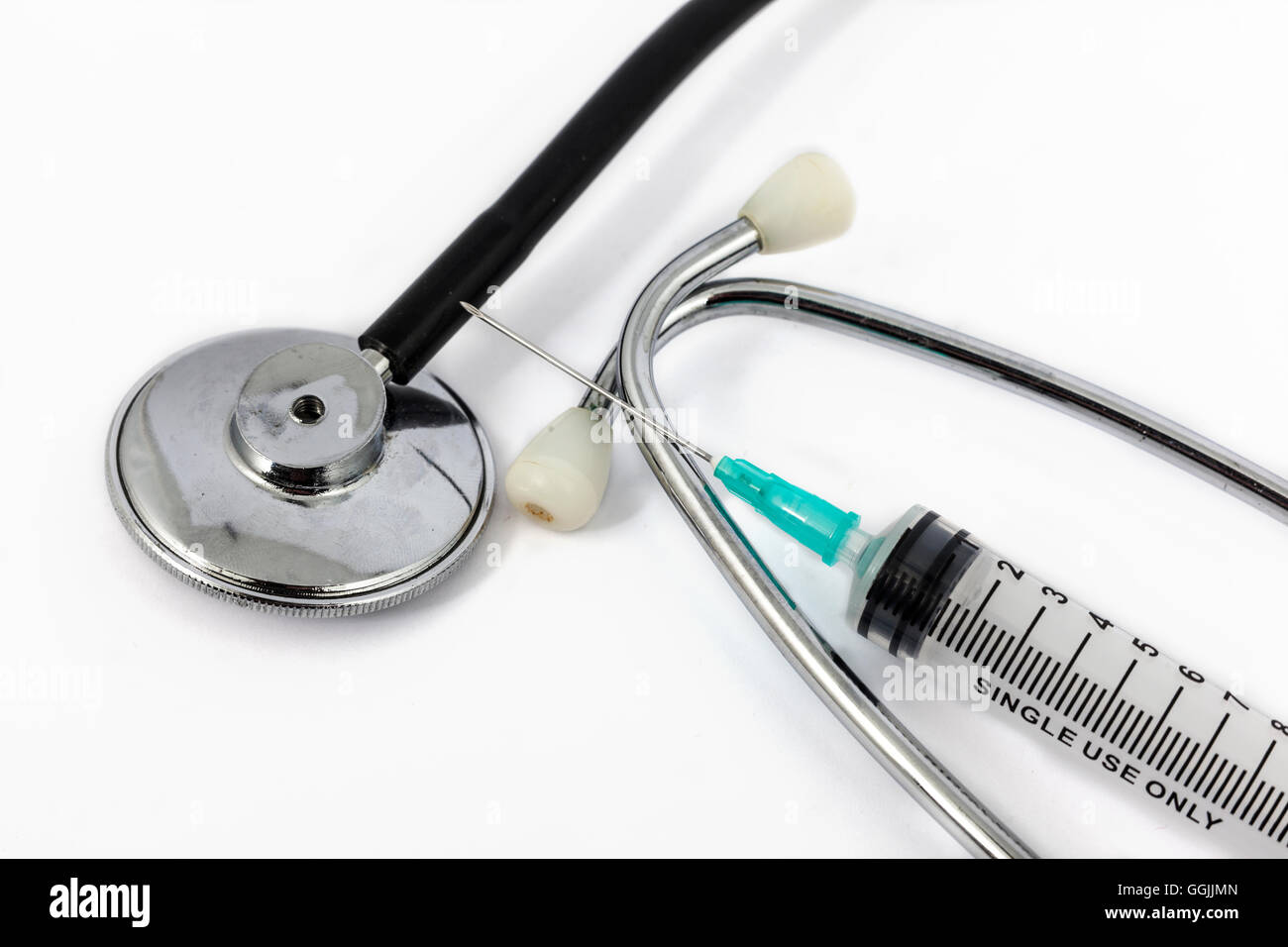 stethoscope and medical syringe with white background Stock Photo - Alamy