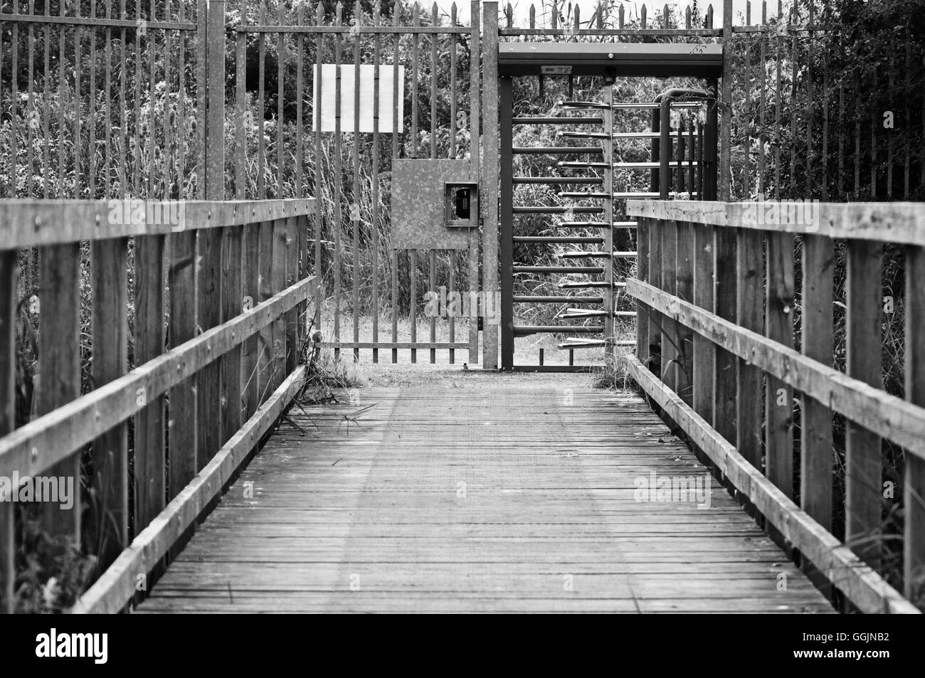 Footbridge and turnstile, the only way out. Stock Photo