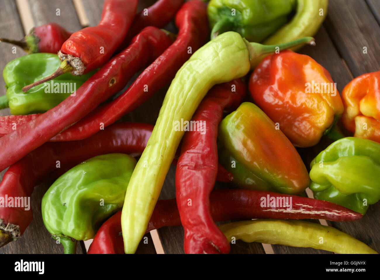 red hot chili peppers on wooden table Stock Photo - Alamy