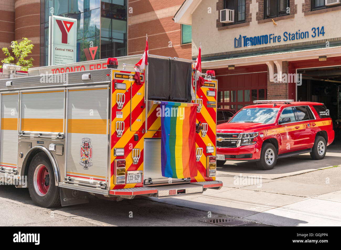 Toronto, CA - 3 July 2016: Toronto Fire Station and firetruck with gay rainbow flag during pride march. Stock Photo