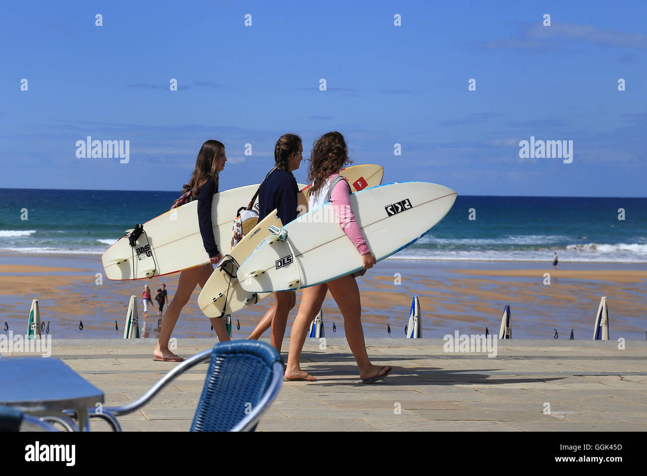 Surfers walking at Zarautz beach, Spain, Basque County Stock Photo