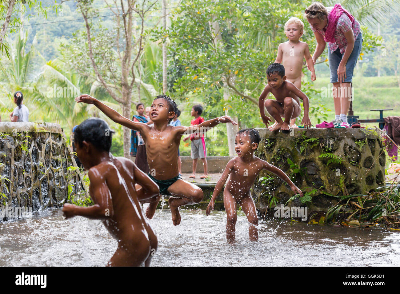 Indonisaian  boy river swim alamy 