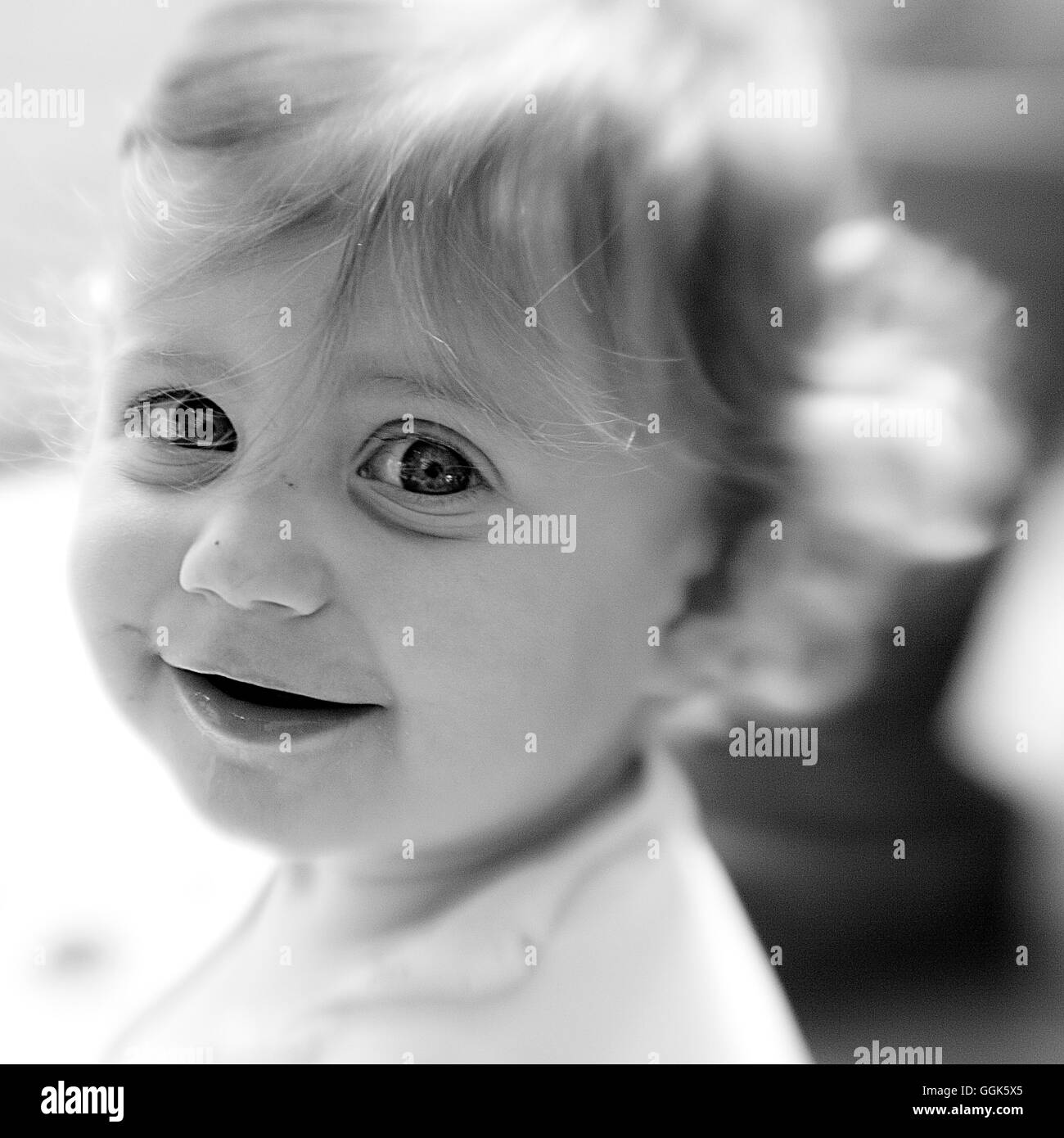 Smiling baby girl with big eyes (black and white photo using Lensbaby technique), Borden, Western Australia, Australia Stock Photo