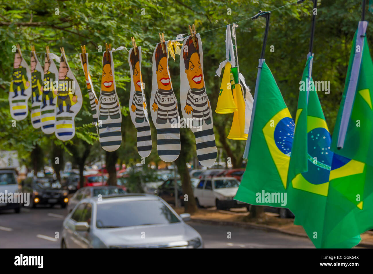 PORTO ALEGRE, BRAZIL - MAY 06, 2016:brazilian flags hanging next to dilma rousseff and sergio moro cartoons in the street Stock Photo