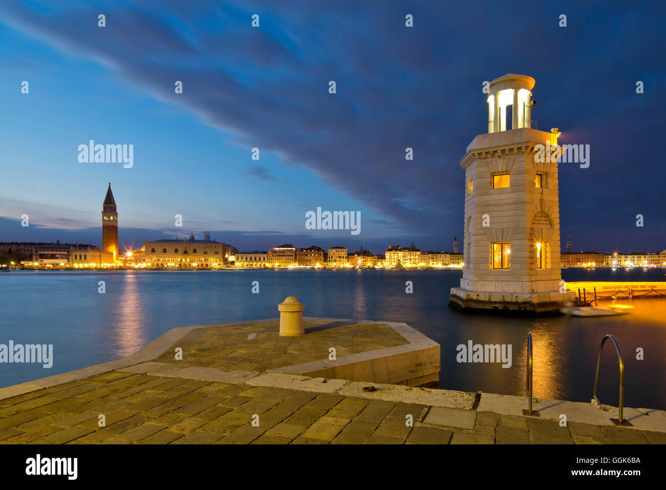 Small lighthouse at the entrance to the marina on Isola di San Giorgo Maggiore island along Bacino di San Marco with view of Cam Stock Photo