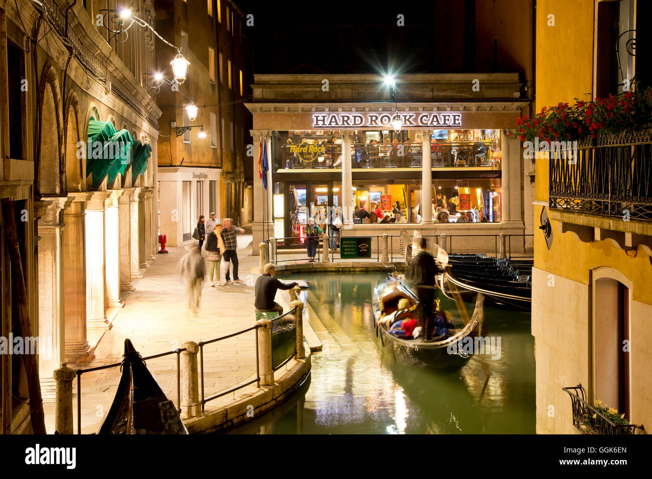 Exterior of Venice Hard Rock Cafe with approaching gondola at night, Venice, Veneto, Italy ...