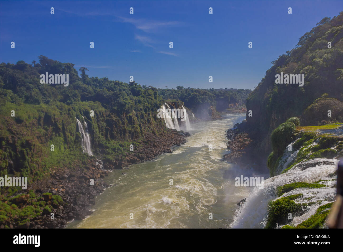 IGUAZU, BRAZIL - MAY 14, 2016: nice view from the iguazu river from the top of one waterfall with the blue sky as background Stock Photo