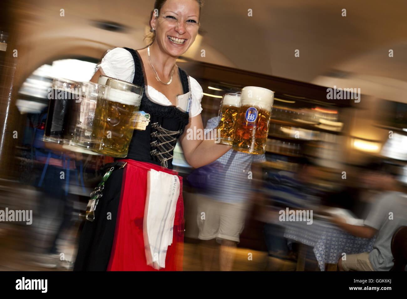 Waitress carrying beer in the Hofbraeuhaus, Munich, Bavaria, Germany, Europe Stock Photo