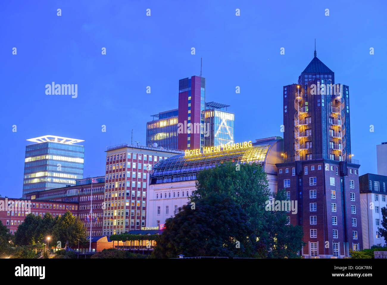Illuminated skyscrapers with hotel Hafen Hamburg, Landungsbruecken, Hamburg, Germany Stock Photo