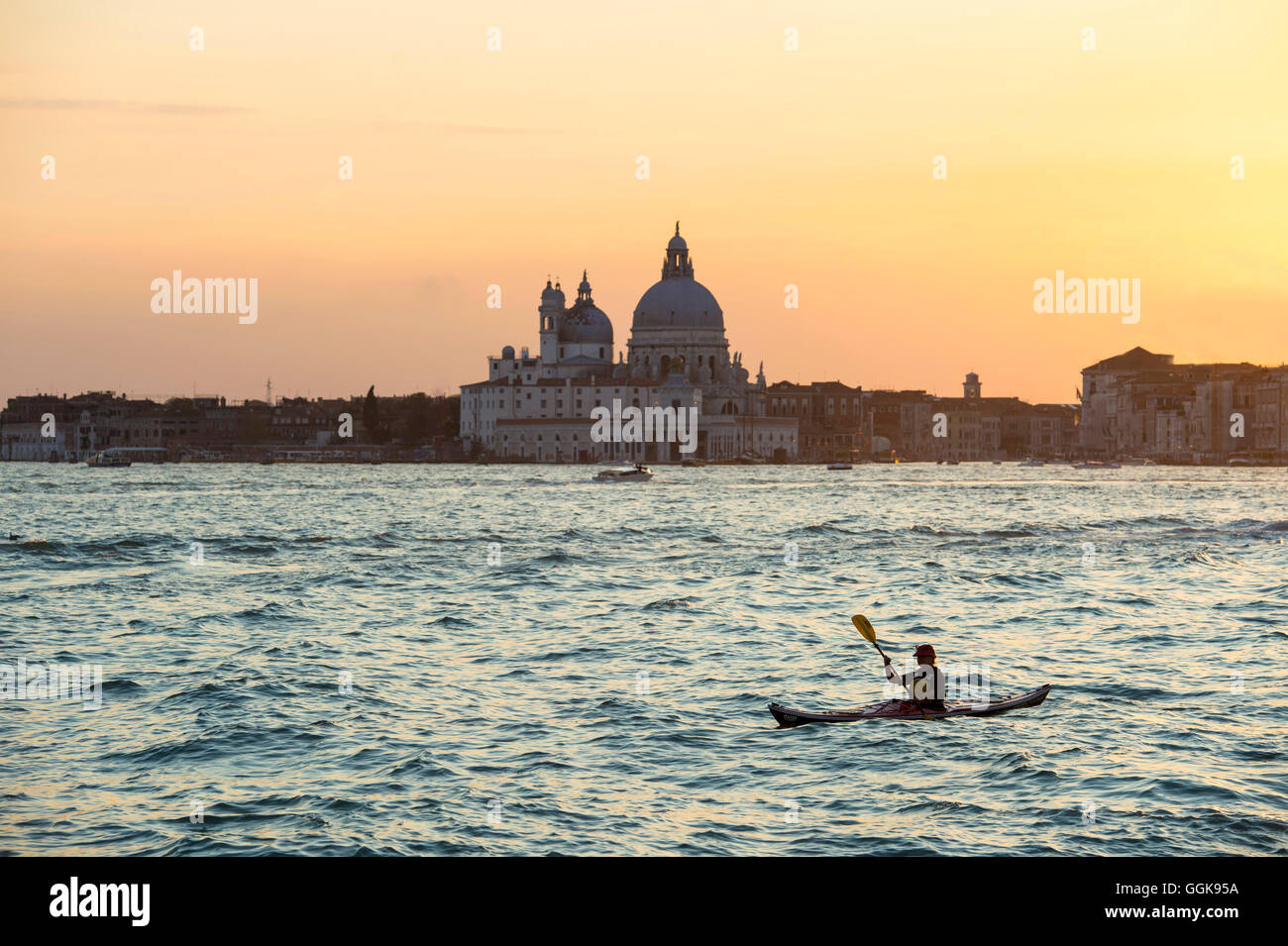 Paddler at sunset on Canal Grande, Venice, Italy Stock Photo
