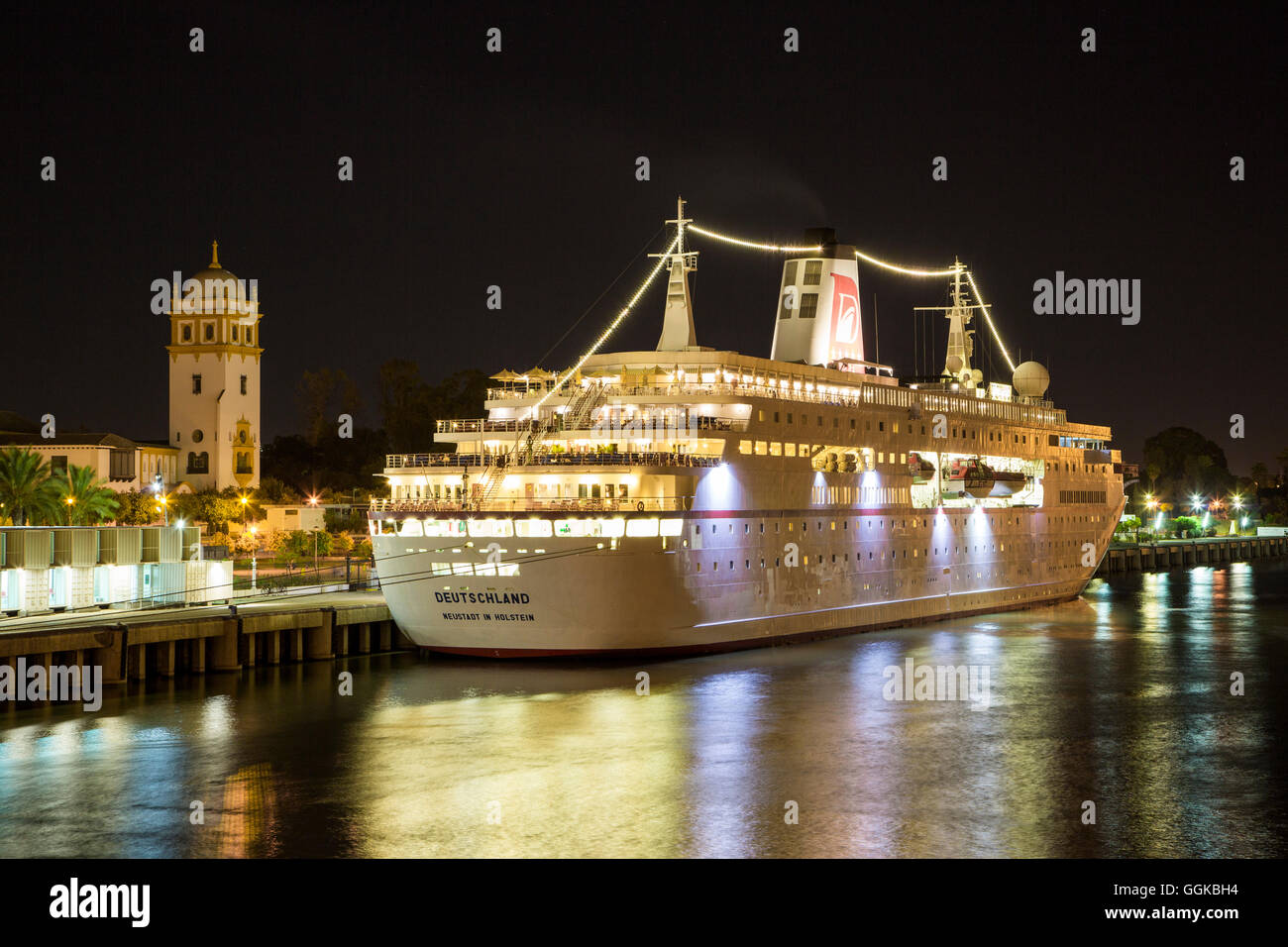 Cruise ship MS Deutschland (Reederei Peter Deilmann) at the pier on Guadalquivir river at night, Seville, Andalusia, Spain Stock Photo