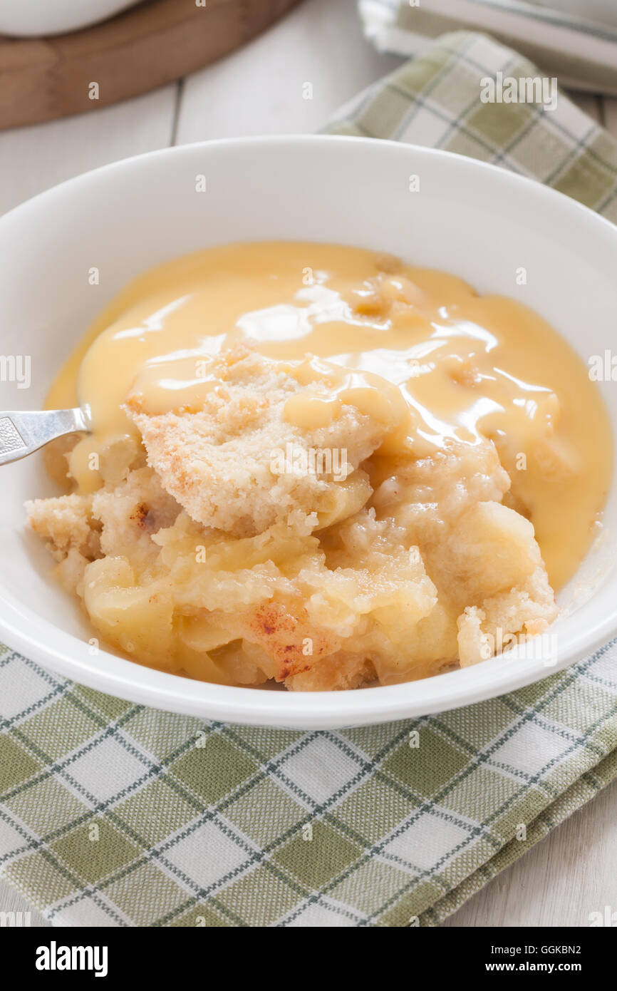 Home made apple crumble or apple cobbler with vanilla custard Stock Photo