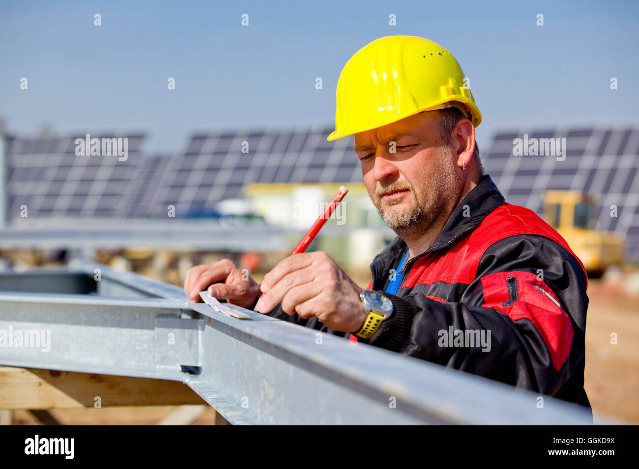 Construction work at the solar park at Peterswald, construction worker with helmet, Neuental, Hesse, Germany, Europe Stock Photo
