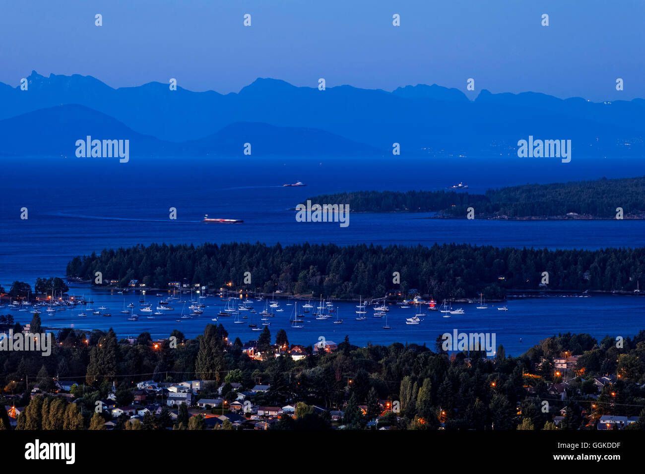 View of city of Nanaimo and BC Coastal mountains at twilight-Nanaimo, British Columbia, Canada. Stock Photo